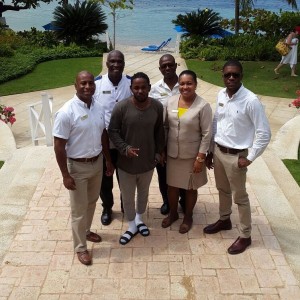 Rapper Kendrick Lamar poses with Round Hill hotel staff in Jamaica
