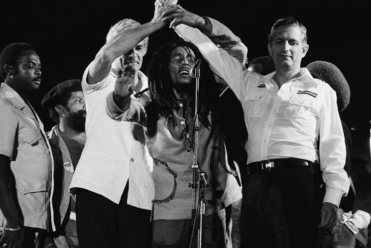 Bob Marley joining the hands of PNP leader Michael Norman Manley, and JLP leader Edward Seaga at the 1978 Peace Concert in Jamaica.