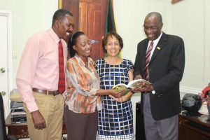 Author and Poet Donna Hart (third left) shares a laugh with Executive Director of the Jamaica Cultural Development Commission (JCDC) Delroy Gordon (right), Events Coordinator at the JCDC, Michael Nicholson (left) and Information Specialist Susan Haye, as they read a passage from Hart’s book Mek Wi Laugh and Talk, An Anthology of Jamaican Poems. Hart recently donated the book to the JCDC, to be added to the library of Jamaica’s premier cultural institution in time for the 2016 Emancipation and Independence Celebrations. Mek Wi Laugh and Talk will join other notable Jamaican works which unearth, develop, preserve and promote the creative talents and cultural expressions of the Jamaican people on the JCDC’s shelves. Hart, a Jamaican poet, is rostered to read her works at the Calabash Literary Festival in Treasure Beach, St. Elizabeth this weekend.  