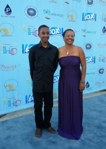 Judith Falloon-Reid on the Blue Carpet with her grandson, Ajani, at the Caribbean Heritage Awards Gala 