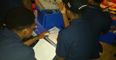 Jamaica College Robotic Team Making slight adjustments to the Engineering Notebook