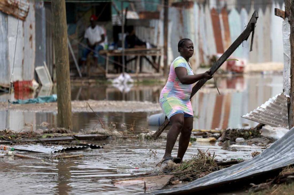 Simone Francis gathers items from her home that were blown away as Hurricane Beryl passed through the area on July 4, 2024 in Old Harbor, Jamaica.