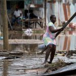 Simone Francis gathers items from her home that were blown away as Hurricane Beryl passed through the area on July 4, 2024 in Old Harbor, Jamaica.