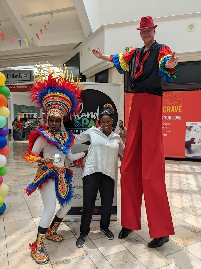 Calibe Thompson (center) With Junkanoo dancer Shantavia and a mocko jumbie at the Island SPACE pop-up display at the Anancy Festival