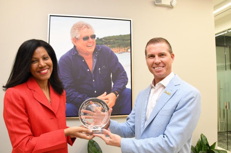 CHTA President Nicola Madden-Greig presents the late Gordon “Butch” Stewart’s Icon of Caribbean Hospitality award to his son Adam Stewart, Executive Chairman, Sandals Resorts International.