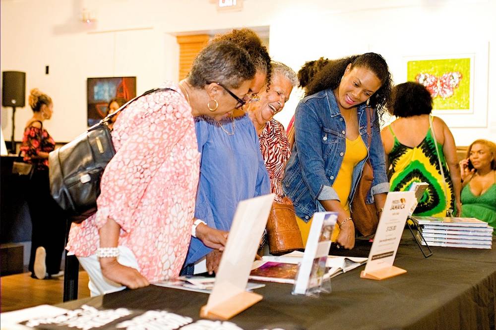 Event goers enjoy the anecdotes and “Jamaicanisms” as they flip through the book.