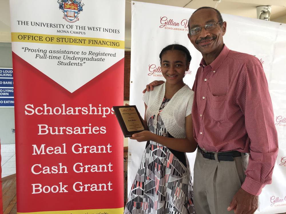 Zori Blake, with her proud father Colin Blake shows the award she received as a recipient of the Gillian Whylie Scholarship for study in Modern Languages at the UWI.