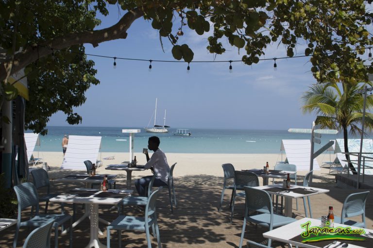 Kim drinking coffee on the beach at Skylark